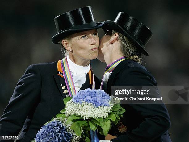 Isabell Werh of Germany kisses winner Anky van Grunscen of the Netherlands on the podium during the Presentation ceremony during the Dressage Grand...