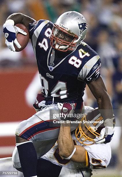 New England Patriots Ben Watson is tackeled by Washington Redskins Adam Archuleta during the first half of a preseason game at Gillette Stadium...