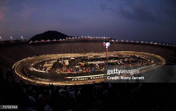 Cars race around the track as night falls during the NASCAR Nextel Cup Series Sharpie 500 on August 26, 2006 at Bristol Motor Speedway in Bristol,...