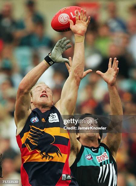 Ian Perrie marks over Troy Chaplin of the Crows during the round 21 AFL match between the Port Adelaide Power and the Adelaide Crows at AAMI Stadium...