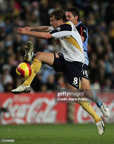 Jamie McMaster of the Mariners is challenged by Mark Milligan of Sydney FC during the round one A-League match between Sydney FC and the Central...