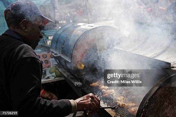 Carl from Jamaica cooks up Jerk Chicken during the Notting Hill Carnival on August 27, 2006 in London, England. People from all over the world meet...