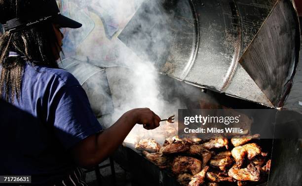 Jamaican Jerk Chicken cooks on the charcoal grill during the Notting Hill Carnival on August 27, 2006 in London, England. People from all over the...