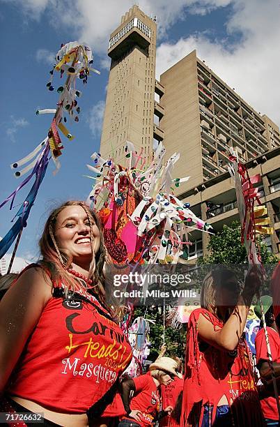 Carnival performers dance past the Trellick Tower during the Notting Hill Carnival on August 27, 2006 in London, England. People from all over the...