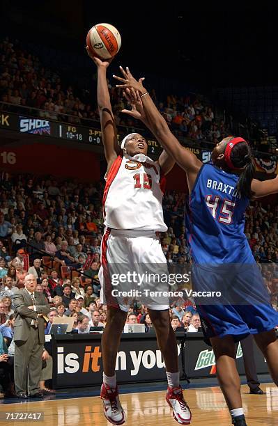 Asjha Jones of the Connecticut Sun shoots against Kara Braxton of the Detroit Shock in game three of the WNBA Eastern Conference Finals August 27,...