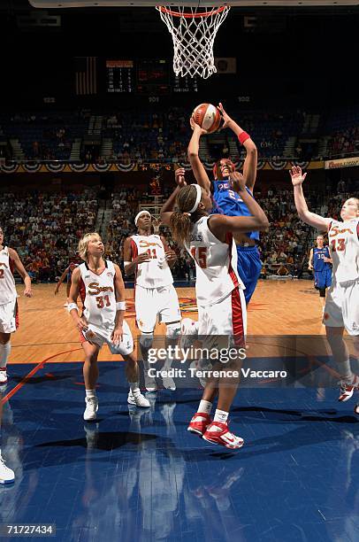 Plenette Pierson of the Detroit Shock goes to the basket against Asjha Jones of the Connecticut Sun in game three of the WNBA Eastern Conference...