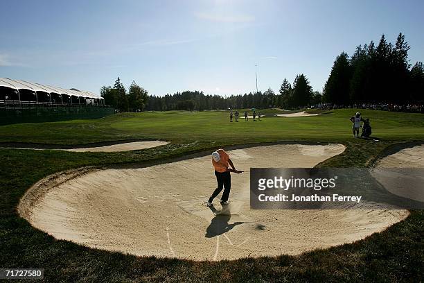 Eduardo Romero of Argentina hits out of the bunker on the 18th hole during the final round of the Champions Tour Jeld-Wen Tradition on August 27,...