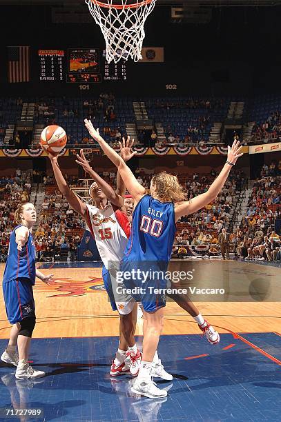 Asjha Jones of the Connecticut Sun goes to the basket against Ruth Riley of the Detroit Shock in game three of the WNBA Eastern Conference Finals on...