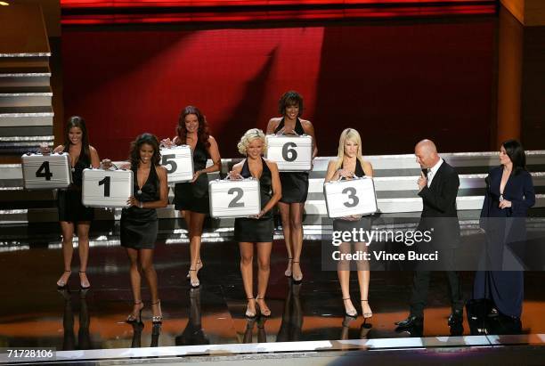 Presenters Howie Mandel and Megan Mullally with "Deal or No Deal" models onstage at the 58th Annual Primetime Emmy Awards at the Shrine Auditorium on...