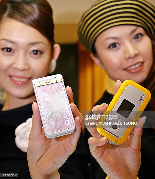 Models display Japanese telecomunication giant KDDi's new mobile phones, produced by Sony Ericsson , with and illuminated panel from inside, and...