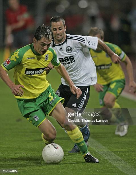 Danny Schwarz of Munich and Markus Palionis of Burghausen battle for the ball during the Second Bundesliga match between Wacker Burghausen and 1860...
