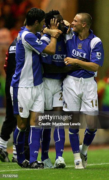 Benjamin Mwaruwari of Portsmouth celebrates scoring his team's second goal with team mates Dejan Stefanovic and Matt Taylor during the Barclays...