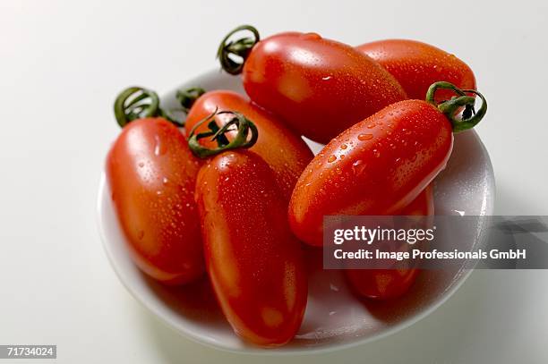 fresh 'date' tomatoes on plate - eiertomate stock-fotos und bilder