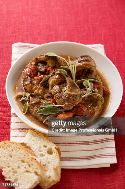 osso buco with tomatoes and sage - osso bucco stock-fotos und bilder