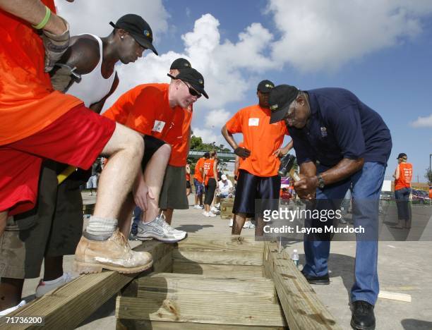 Legend Willis Reed and NBA player Bobby Jackson of the New Orleans/Oklahoma City Hornets assist in rebuilding the playground with Hornets staff...
