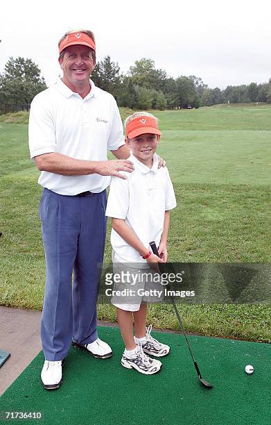Pro-golfer Fred Funk poses for a photo with his son Taylor during the Entertainment Golf Association?s celebrity golf tournament presented by Vonage...