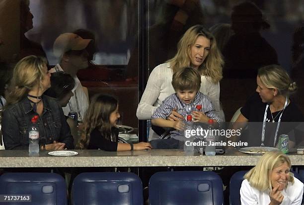 Steffi Graf , wife of Andre Agassi, and their son Jaden Gil watch Agassi play against Andrei Pavel of Romania during the first round of the US Open...