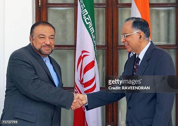 Iran Deputy Minister of Foreign Affairs, Mehdi Safari shakes hands with Indian Secretary for the Ministry of External Affairs, Rajiv Sikri , before a...