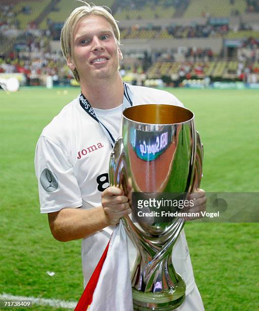 Christian Poulsen of Sevillia celebrates after winning the UEFA Super Cup between FC Barcelona and FC Sevilla at the Stadium Louis II on August 25,...
