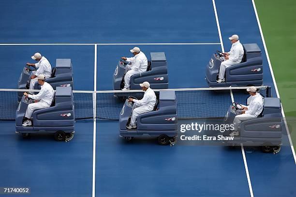 Court attendants use machines to dry the court during a rain delay at the U.S. Open at the USTA Billie Jean King National Tennis Center in Flushing...