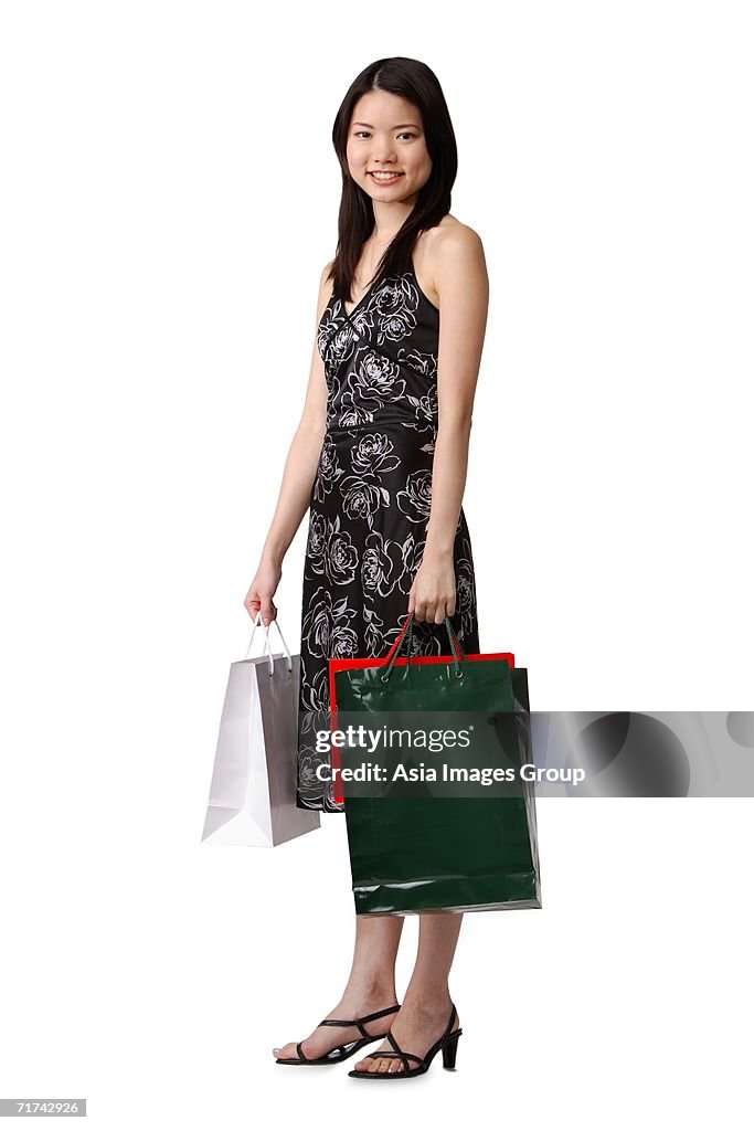 Young woman carrying shopping bags, portrait