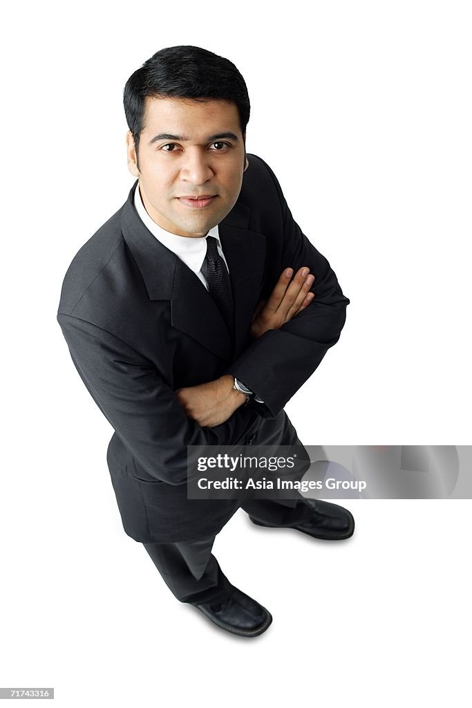 Businessman, arms crossed, looking at camera, portrait