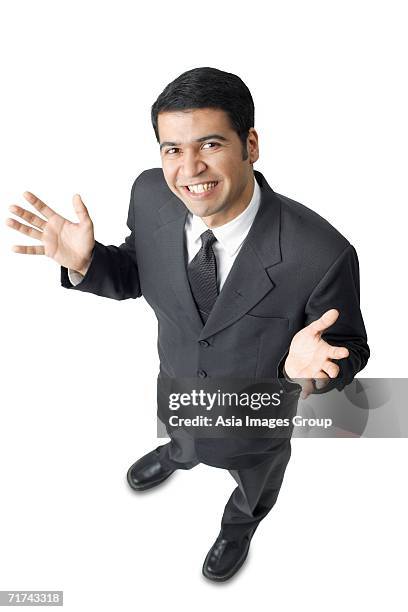 businessman, hands raised, palms facing up, looking at camera - business person facing away from camera stockfoto's en -beelden