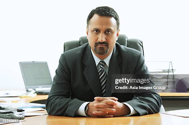 businessman at desk, looking at camera, hands clasped - male portrait suit and tie 40 year old stock pictures, royalty-free photos & images