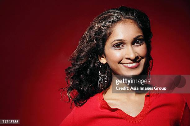 woman looking at camera, pulling hair back from face - woman pulling hair back stock pictures, royalty-free photos & images