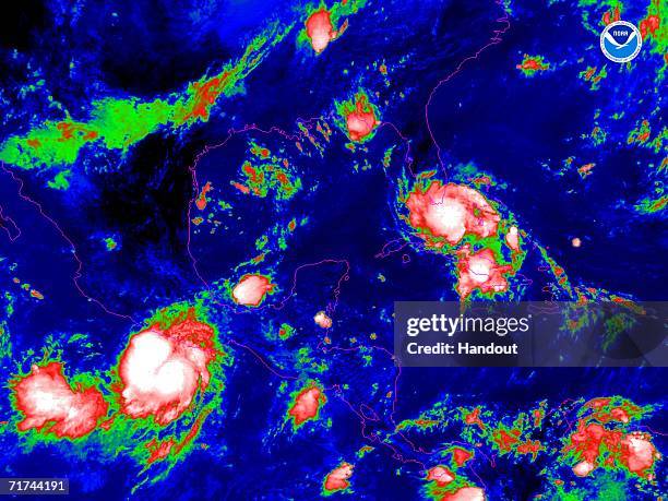 In this satellite colorized infrared image provided by the National Oceanic and Atmospheric Administration, Tropical Storm Ernesto is shown at 1:00...