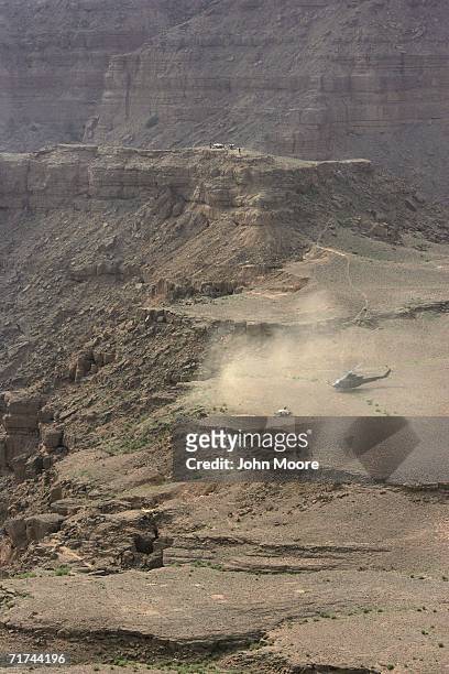 Pakistani army helicopter lands near a cave in a rugged ravine where the army says that the body of Baloch rebel leader Nawab Akbar Bugti lies...