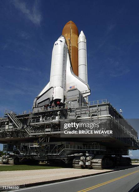 The US space shuttle Atlantis atop its mobile launch platform riding a crawler transporter head back to launch pad 39-B at Kennedy Space Center in...