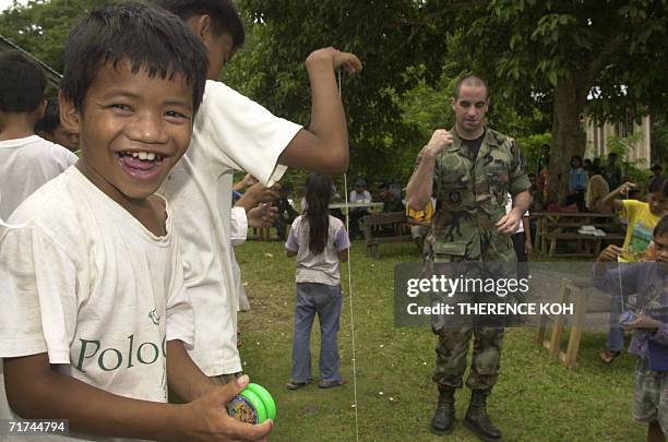 Young Muslim boy smiles after receiving a yo-yo from a US soldier 29 August 2006 during a medical mission at Karundung Elementary School in the...