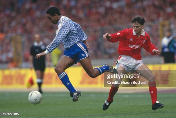 Paul Ince of Manchester Utd holds onto the ball from the Nottingham Forest defender Gary Crosby during their Rumbelows Football League Cup Final...