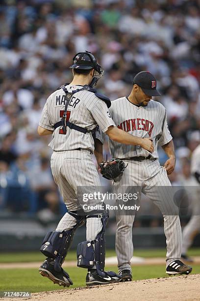 Joe Mauer of the Minnesota Twins talks with Johan Santana during the game against the Chicago White Sox at U.S. Cellular Field in Chicago, Illinois...