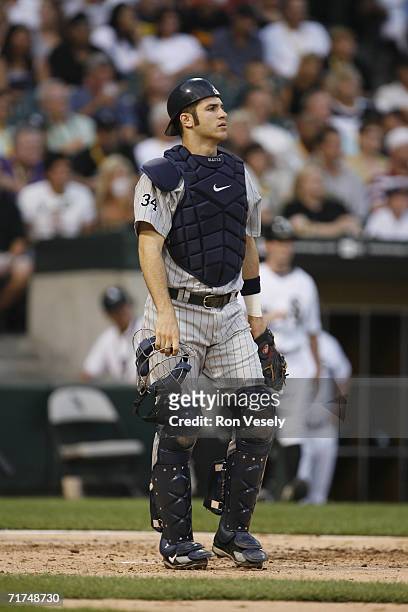 Joe Mauer of the Minnesota Twins looks on while catching during the game against the Chicago White Sox at U.S. Cellular Field in Chicago, Illinois on...