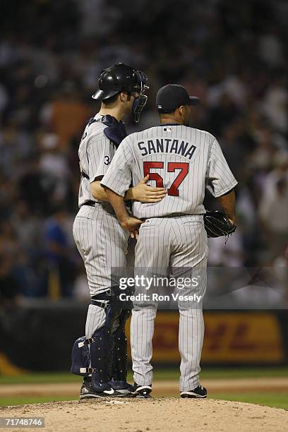 Joe Mauer of the Minnesota Twins talks with Johan Santana during the game against the Chicago White Sox at U.S. Cellular Field in Chicago, Illinois...