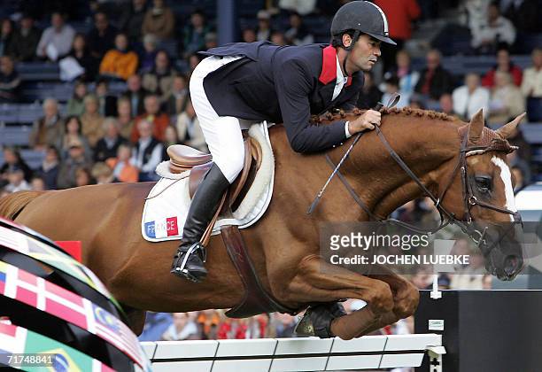 French rider Florian Angot on "First De Launay" jumps during the first round of the jumping competition of the World Equestrian Games in Aachen, 30...