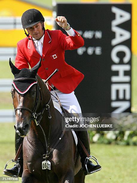 Canadian rider Eric Lamaze on "Hickstead" celebrates after a jump during the first round of the jumping competition of the World Equestrian Games in...