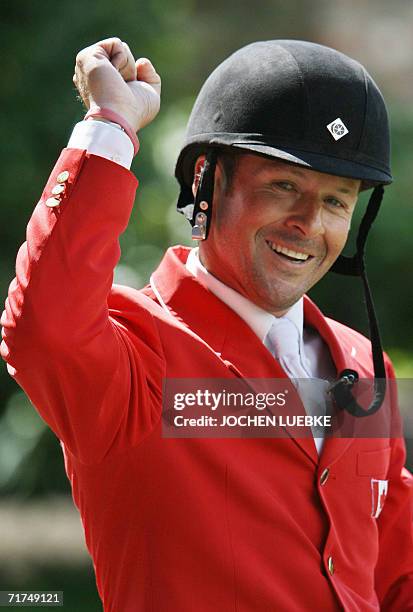 Canadian rider Eric Lamaze on "Hickstead" celebrates after a jump during the first round of the jumping competition of the World Equestrian Games in...