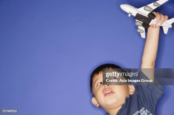 young boy playing with toy airplane - arms outstretched stock pictures, royalty-free photos & images