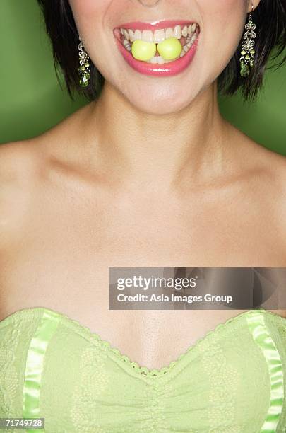 woman with two sweets between teeth - candy lips stock pictures, royalty-free photos & images