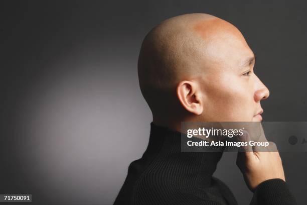 man with shaved head, hand on chin, profile - shaved head profile stock pictures, royalty-free photos & images