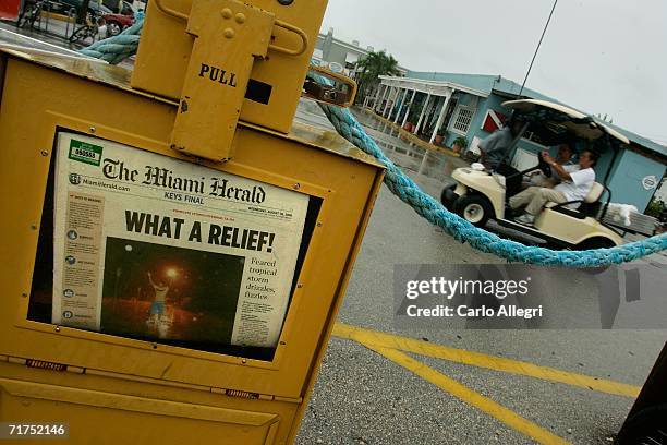 The headline of the Miami Herald inside a sidewalk newspaper box reflects the turn of events in South Florida as Tropical Storm Ernesto remained...