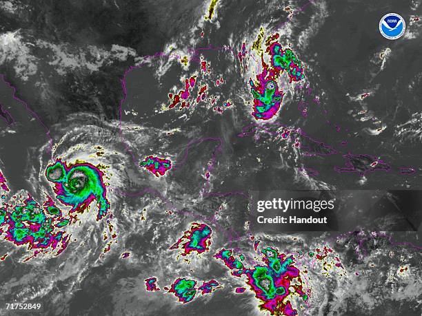 In this satellite colorized infrared image provided by the National Oceanic and Atmospheric Administration, Tropical Storm Ernesto is shown at 11:00...