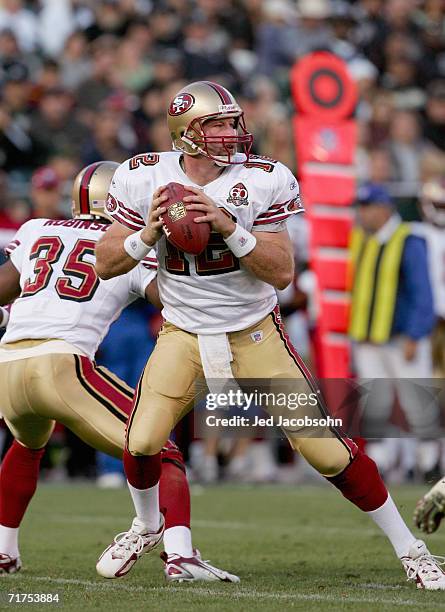 Trent Dilfer of the San Francisco 49ers drops back to pass during a preseason NFL game against the Oakland Raiders at McAfee Coliseum on August 20th,...