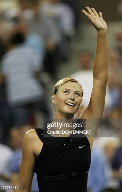 Third seed Maria Sharapova of Russia waves to the crowd after her win over Michaella Krajicek of the Netherlands 30 August 2006 in the first round of...