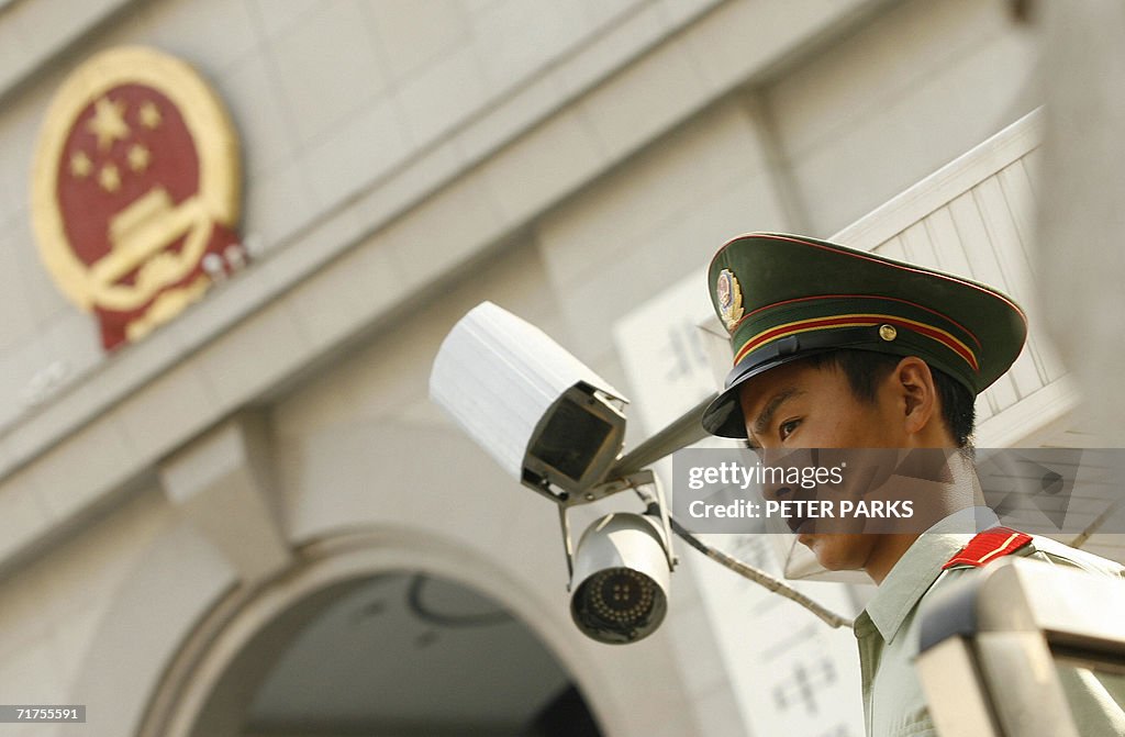 A Chinese paramilitary policeman stands