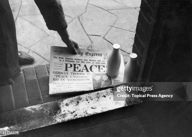 Morning copy of the Daily Express reassures the public that Britain will not be going to war, 30th September 1938. The picture beneath shows British...