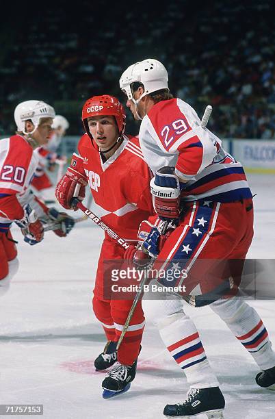 Russian professional hockey player Igor Larionov , center for CSKA Moscow and on the ice as a member of Team USSR, battles American hockey player...